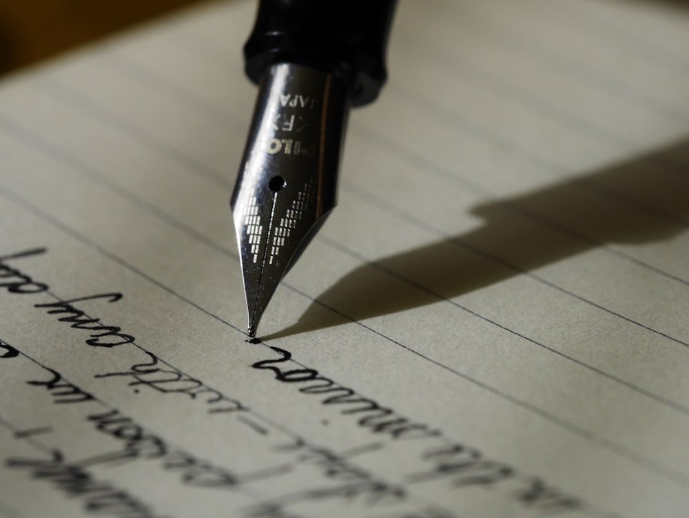 Hands writing notes with a fountain pen