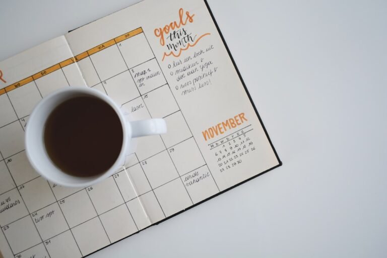 Open planner with a coffee cup